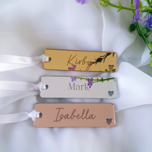 Three personalised acrylic bookmarks made of gold, silver, and rose gold acrylic