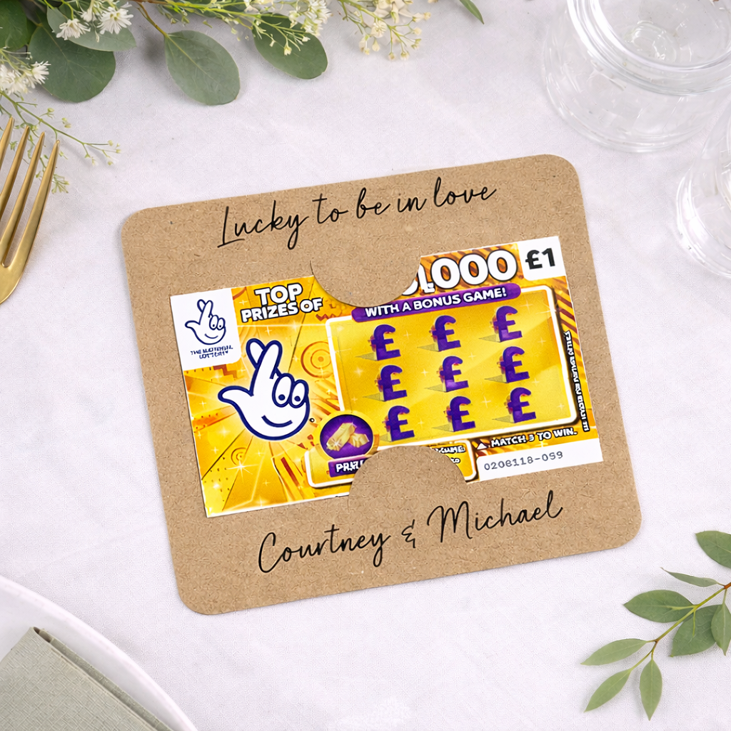 Personalised fun wedding favour scratch card on a white wedding table to cutlery 
