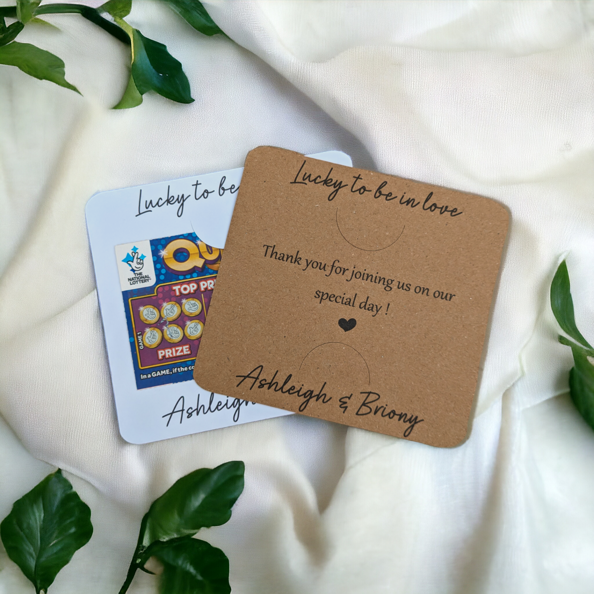 Cheap wedding favour idea, white and kraft personalised scratch card holders on white fabric background