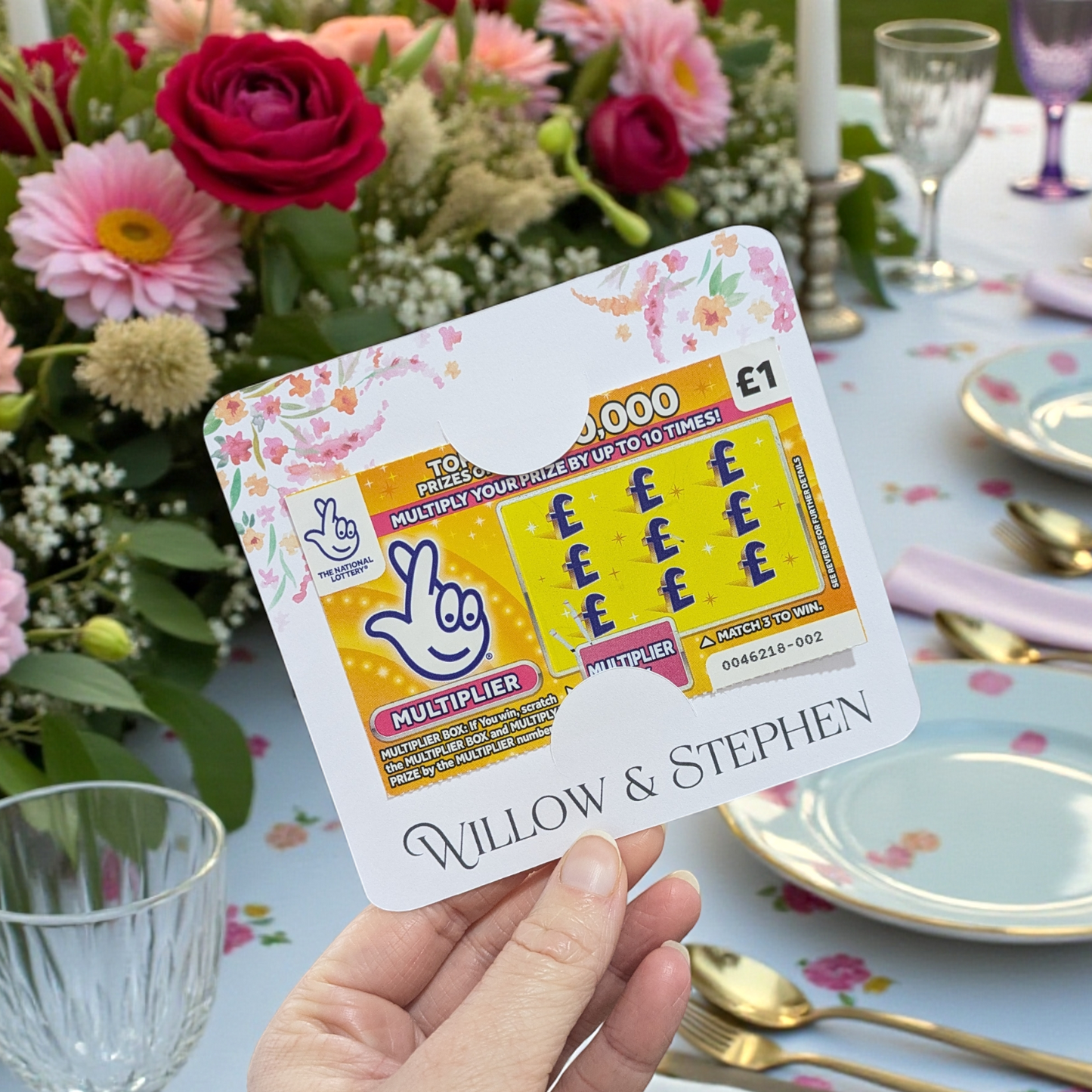 bright floral wedding favour scratch card holder in front of a wedding table
