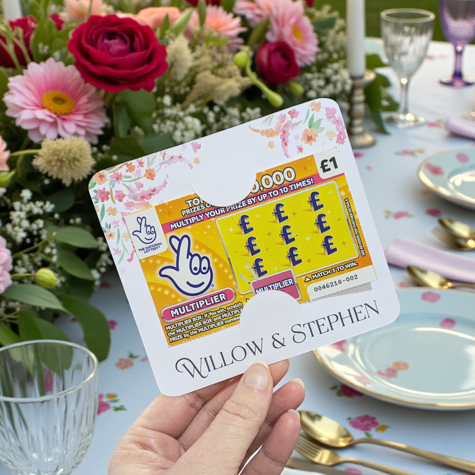 bright floral wedding favour scratch card holder in front of a wedding table