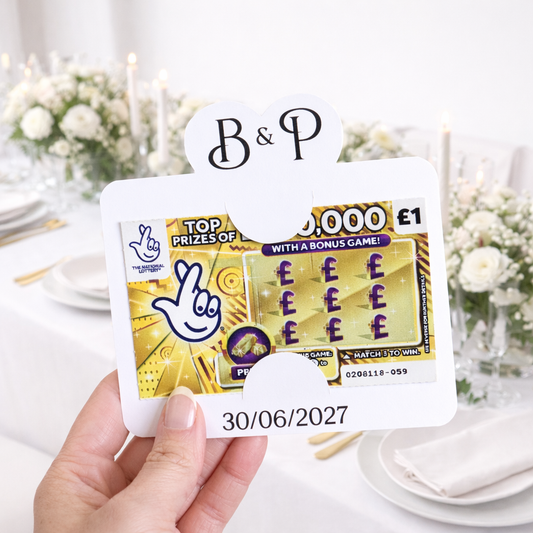 wedding favour scratch card holder being held in front of a wedding table
