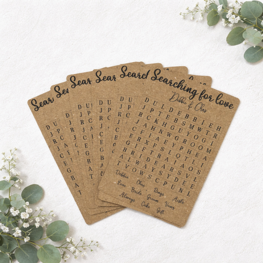 wedding table game that's a word search in a stack on white background with florals in the corner