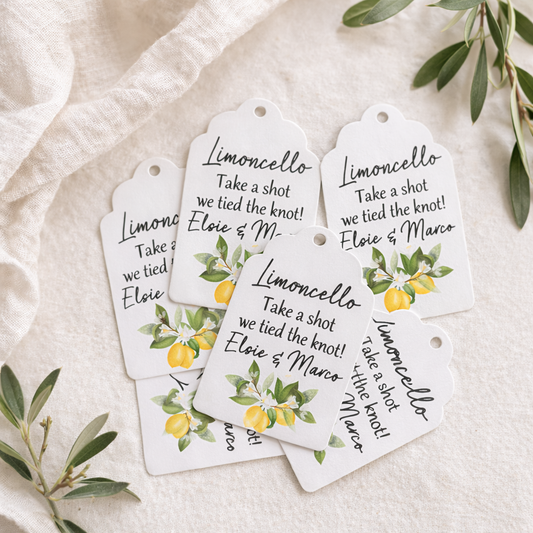 Custom Mediterranean-style wedding favour tags featuring a bright lemon and blossom motif, expertly printed on scalloped white card with the playful phrase "Take a shot we tied the knot!"