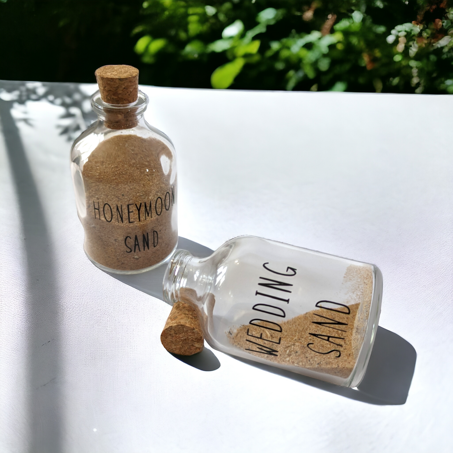 glass bottle with cork tops filled with sand from a honeymoon and wedding. A great destiantion wedding gift