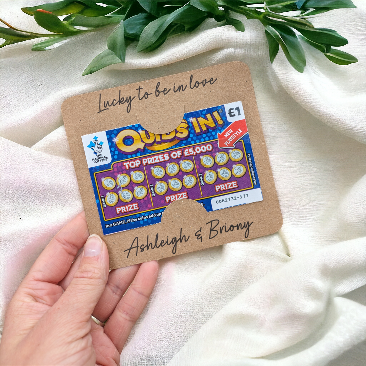 Scratch card wedding favour on textured fabric background. Inexpensive wedding favour idea