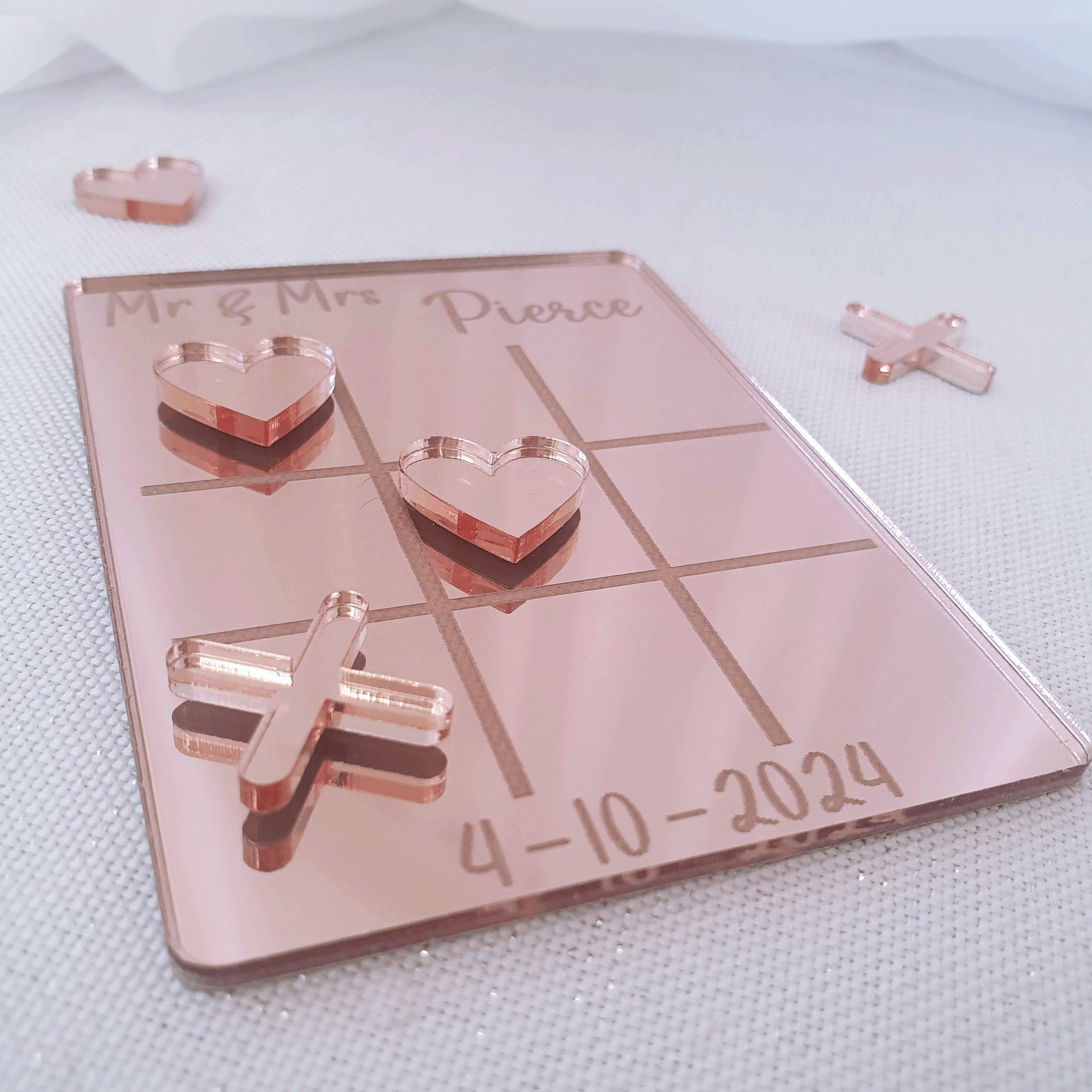 Personalised rose gold acrylic tic tac toe wedding table game.